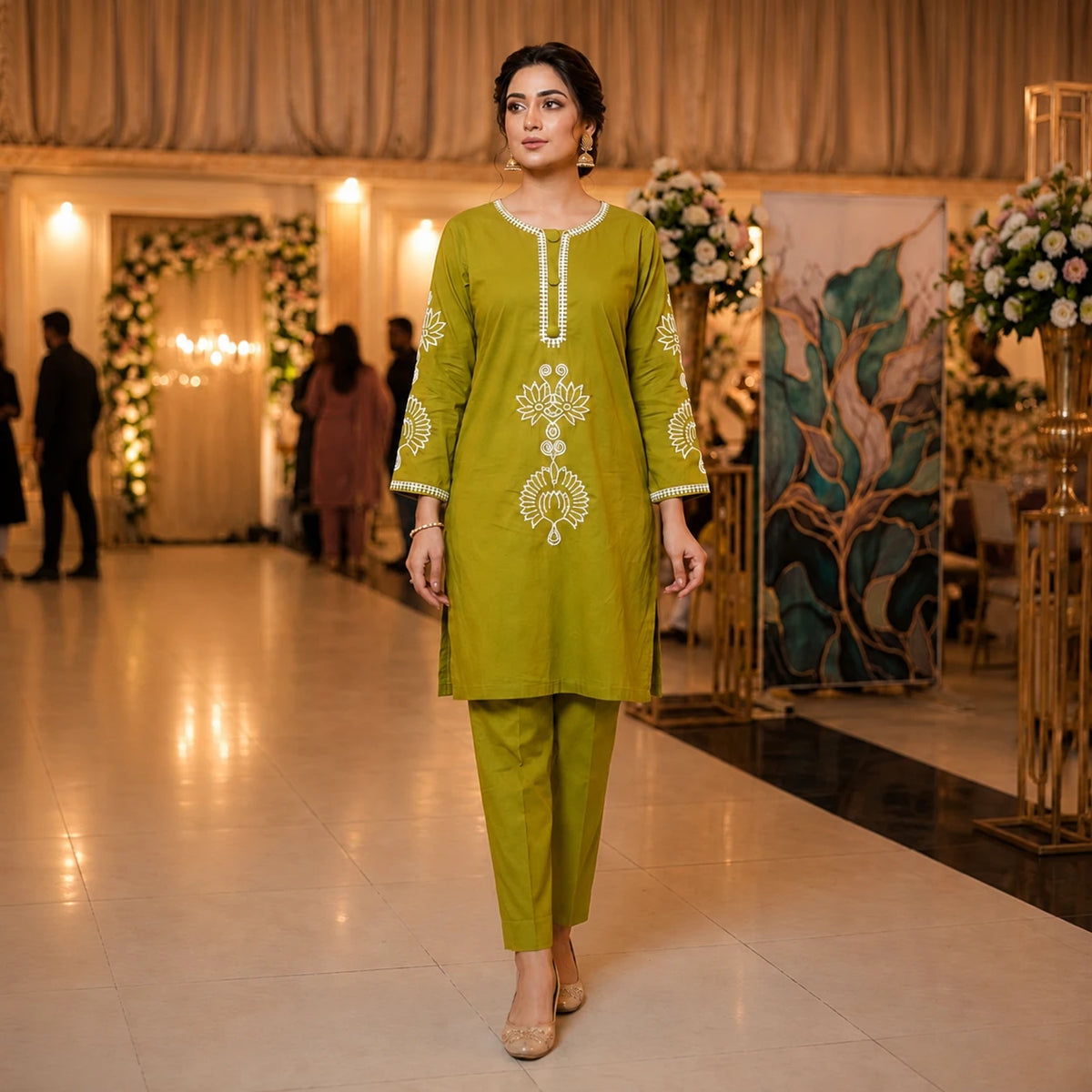 Woman wearing an olive green embroidered straight kurta with matching pants