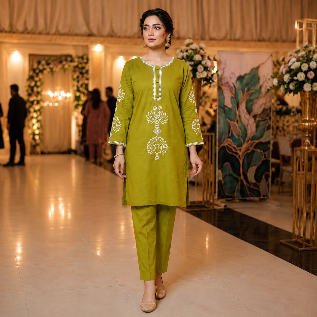Woman wearing an olive green embroidered straight kurta with matching pants