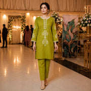 Woman wearing an olive green embroidered straight kurta with matching pants