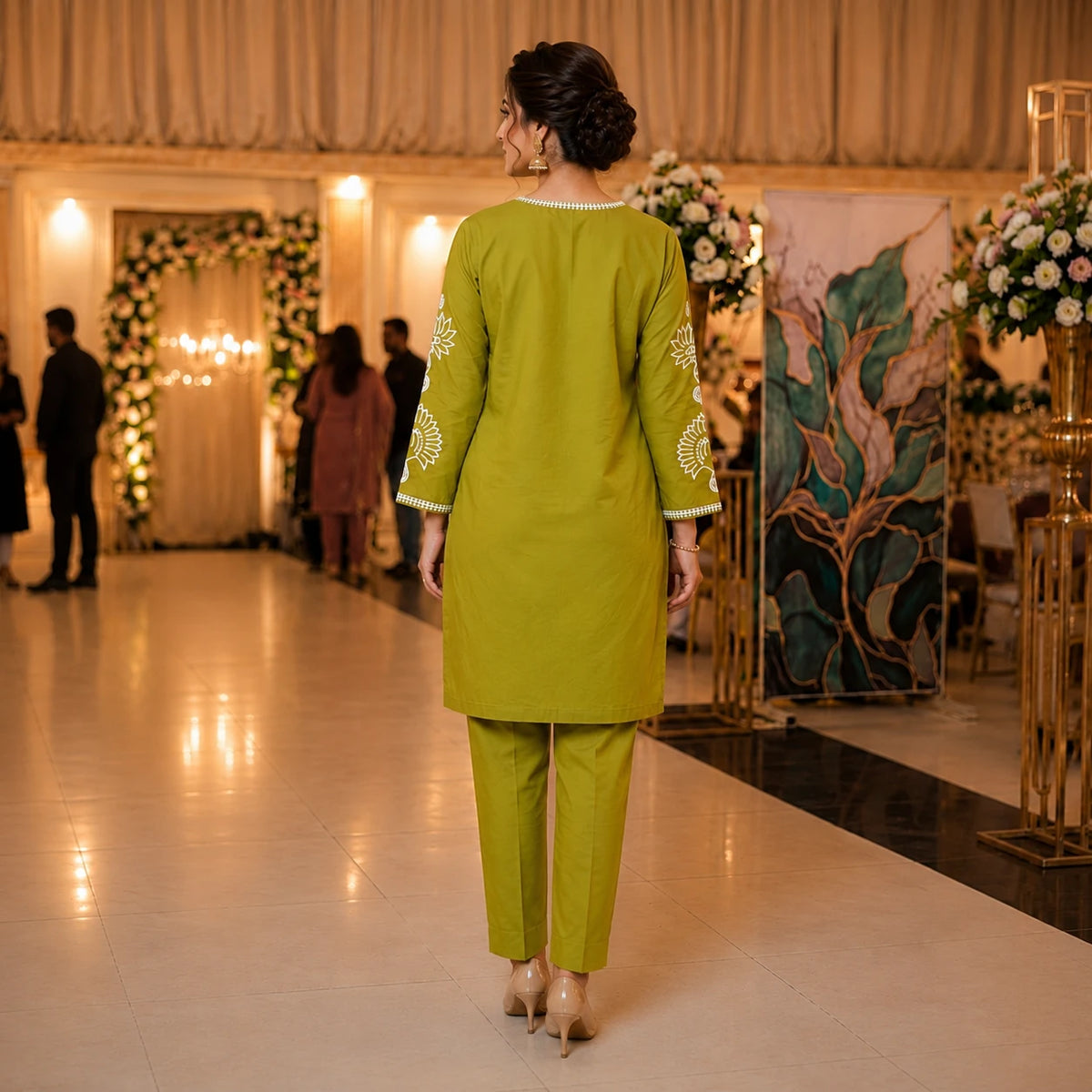 Woman wearing an olive green embroidered straight kurta with matching pants