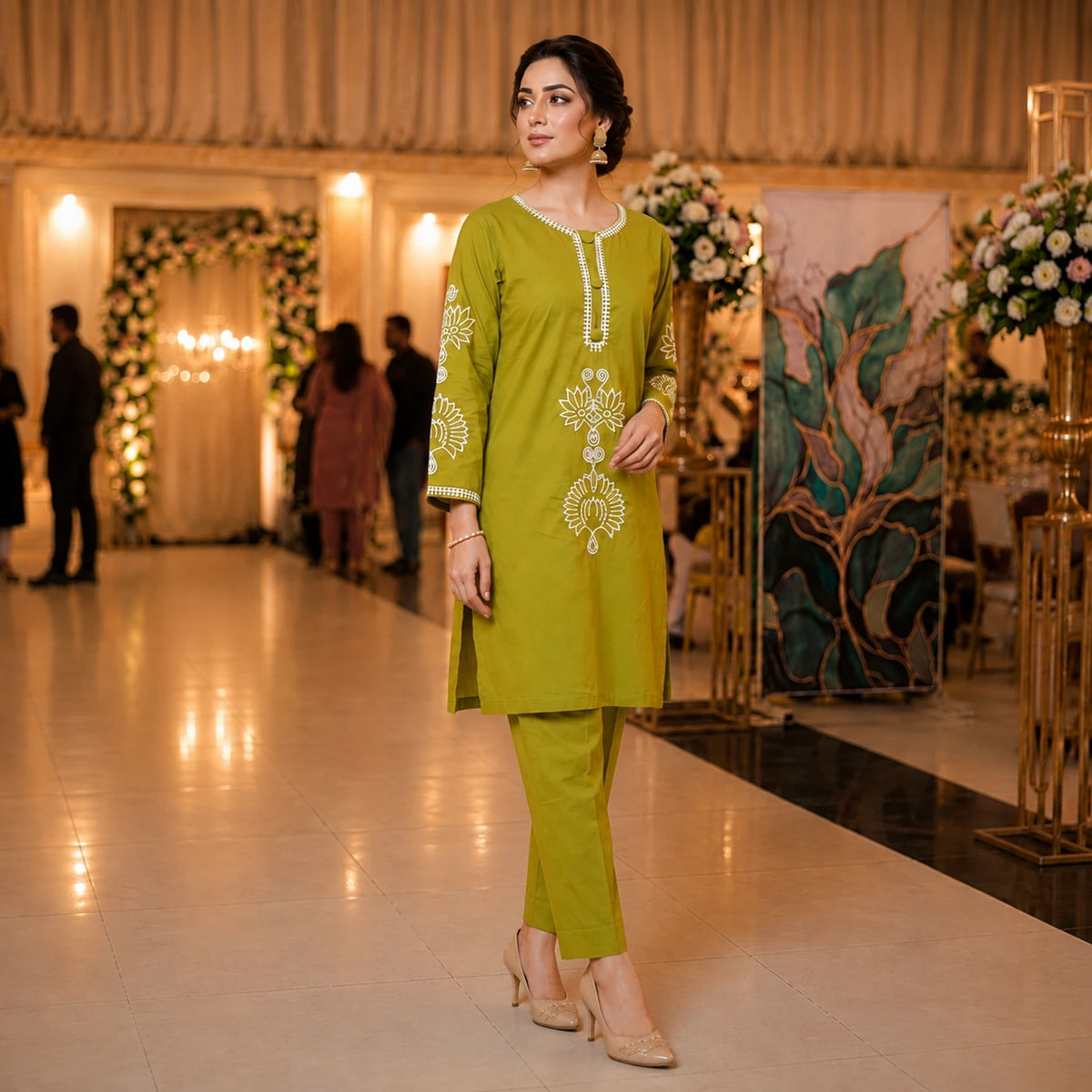 Woman wearing an olive green embroidered straight kurta with matching pants