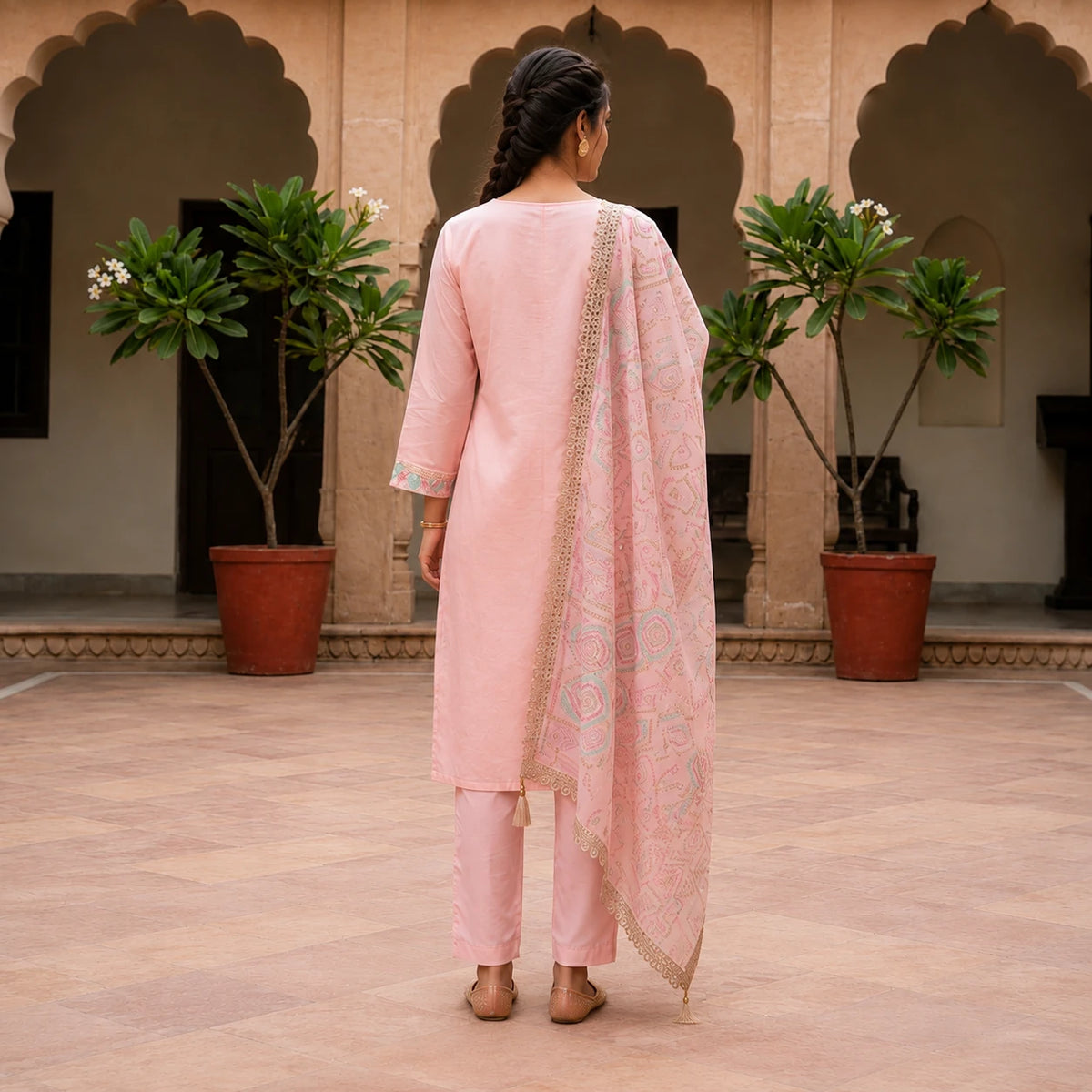 Woman wearing blush pink embroidered straight kurta pant set with printed dupatta