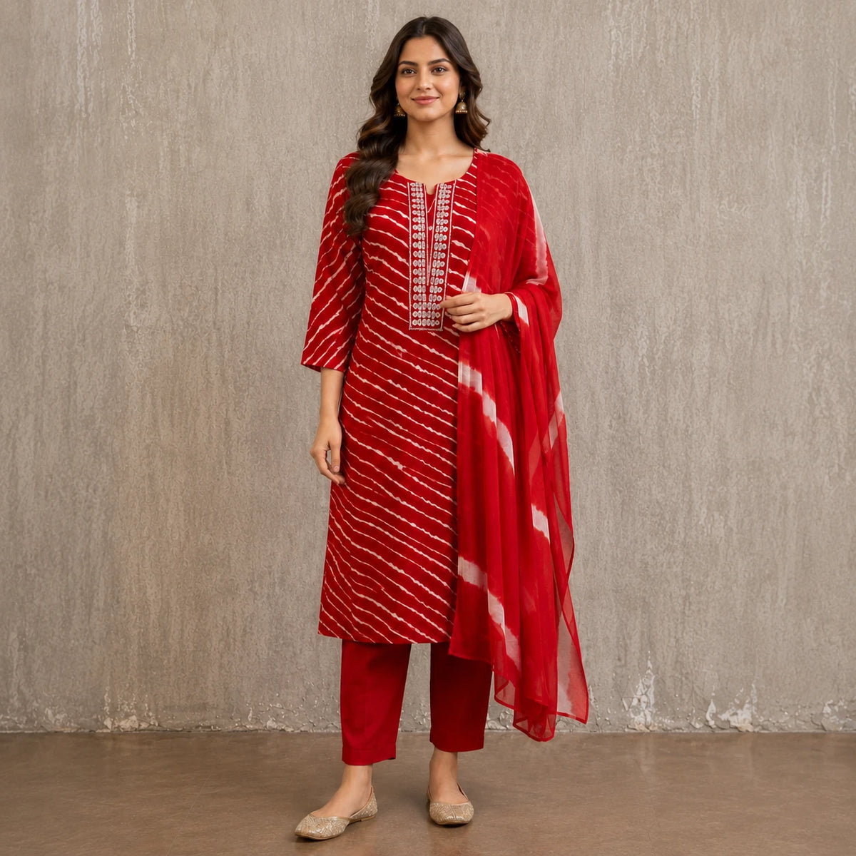 Woman wearing a red printed kurta pant set with white diagonal stripes and contrast dupatta