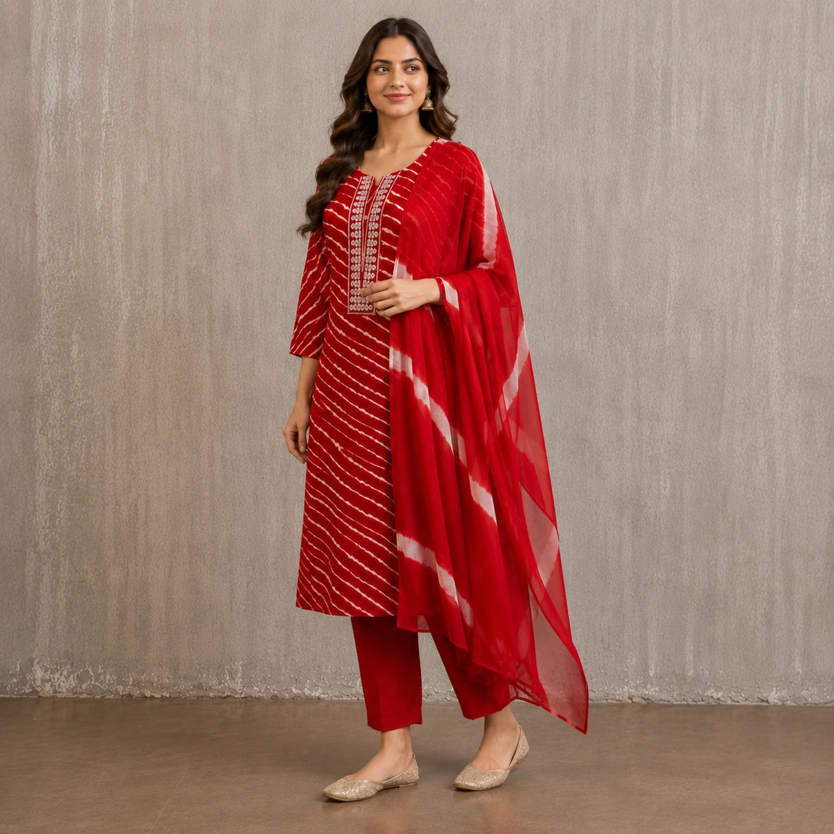 Woman wearing a red printed kurta pant set with white diagonal stripes and contrast dupatta