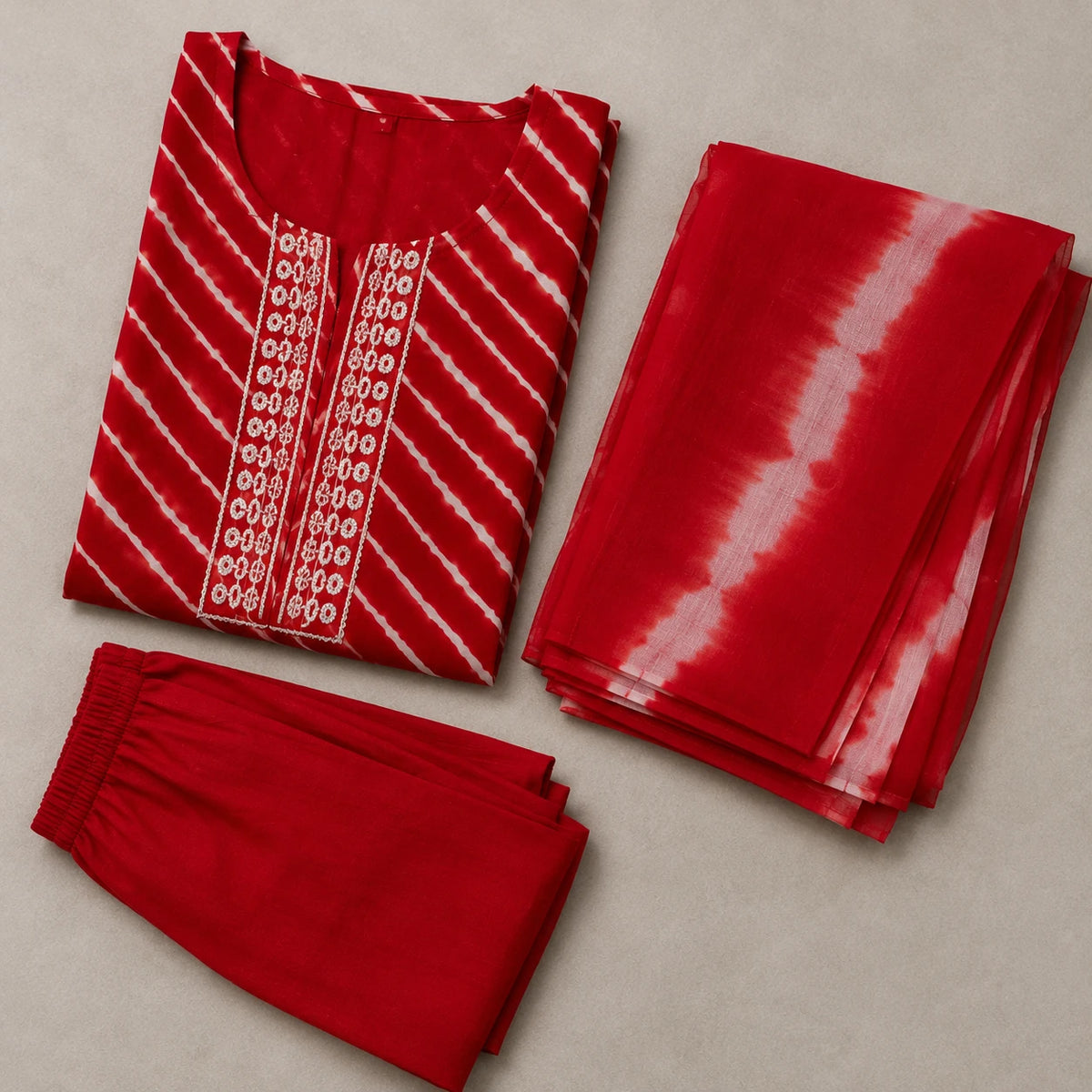 Woman wearing a red printed kurta pant set with white diagonal stripes and contrast dupatta
