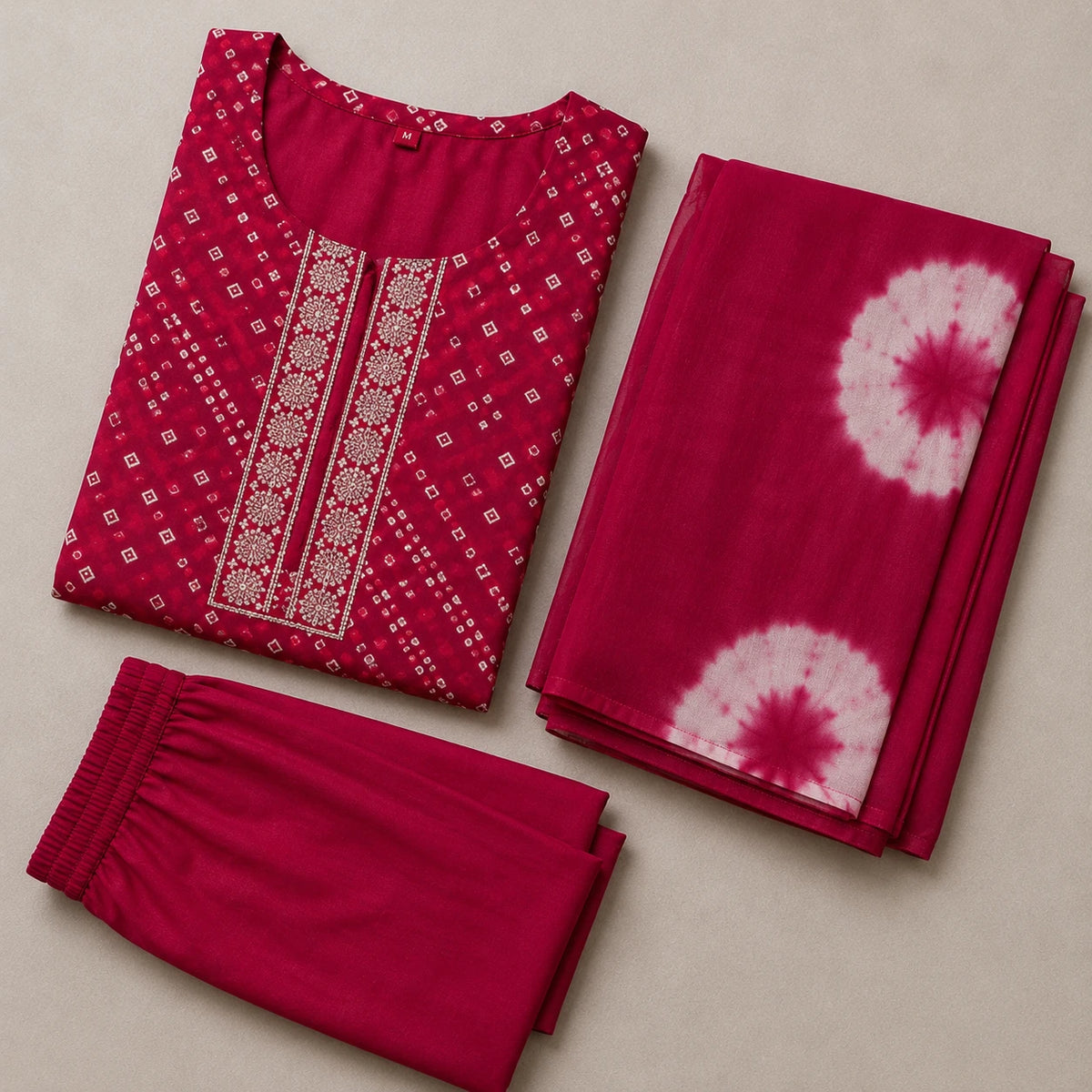 Woman wearing a magenta Bandhani-inspired printed kurta pant set with a contrast dupatta