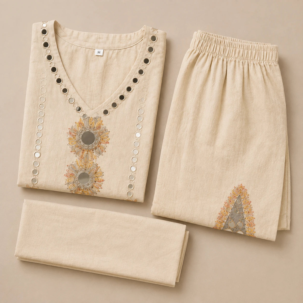 Woman wearing an ivory mirror embroidered V-neck kurta with wide-leg palazzo pants