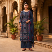 Woman wearing a navy blue geometric printed kurta with wide-leg palazzo pants and matching dupatta